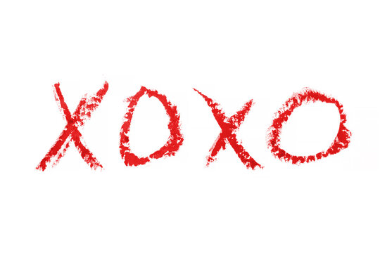 kiss word romantic xoxo written by lipstick trace red on white background