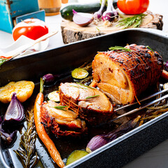 Lecere roll roast with vegetables and herbs.