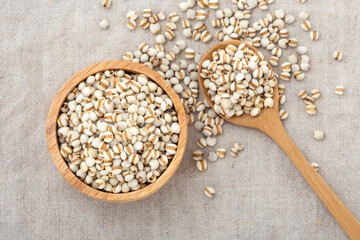 Pearl barley in wooden bowl with spoon
