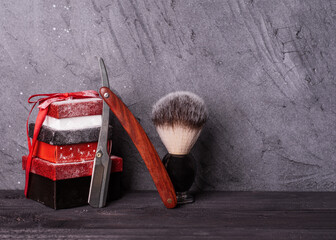 Razors, brush, christmas gift  on a wood background