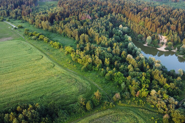 Aerial landscape view, summer forest, fields and lake.
