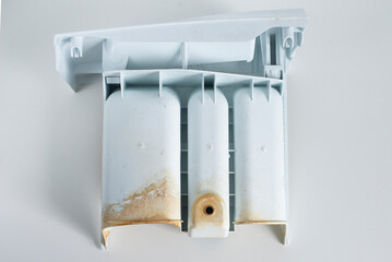 Cleaning the white dirty container for the washing machine with traces of rust. Poor quality water leads to damage to the device - prevention and care of the washing machine.