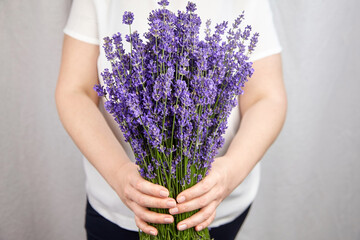 Woman holding lavender flowers bouquet