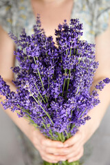 Woman holding beautiful romantic natural lavender flowers bouquet