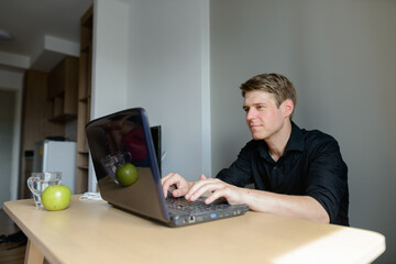 Portrait of young handsome blond businessman working from home