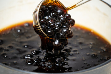 Cooking, boiling brown sugar flavor tapioca pearl balls, ingredient of bubble tea, preparing food...