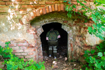Man in the interior of an old ruined abandoned church building