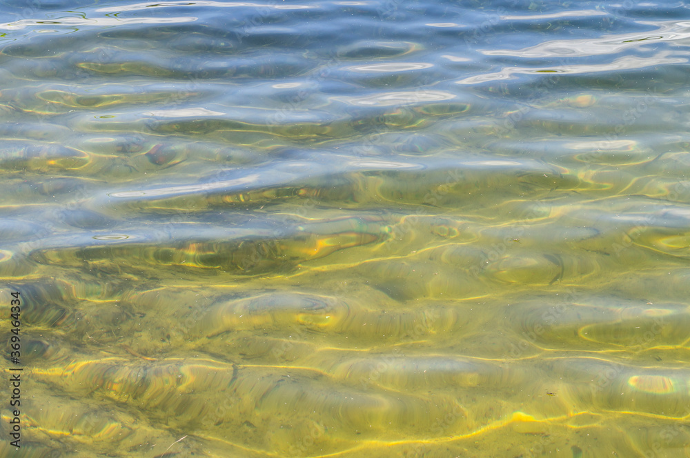 Poster beautiful sandy bottom of the lake. view through clear water