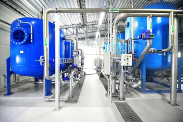 Foto op Plexiglas Large blue tanks in a industrial city water treatment boiler room. Wide angle perspective. Special equipment, technology, drinking water supply, chemical modifications, environmental conservation © Aastels
