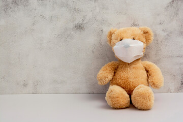 Teddy bear wearing protective mask. Coronavirus protection. Toy bear in mask to prevent virus spread.
