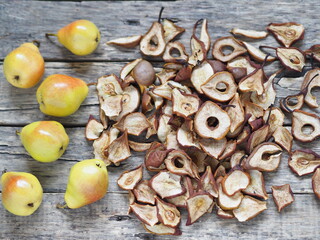 Healthy snack.Dried and fresh pears on a wooden background. Home preparations for future use.