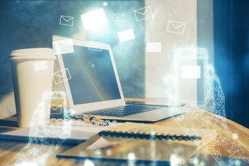 Desktop computer background in office and flying envelops hologram drawing. Double exposure....