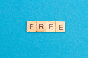 FREE word from wooden blocks on a blue background