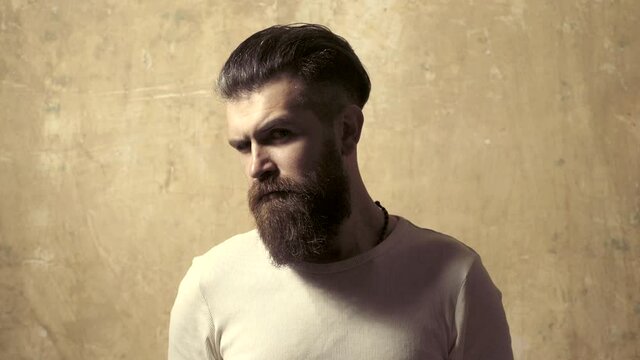 High fashion man look. Confident handsome man. High Fashion male model posing at mirror. Morning man. Bearded man with long beard and mustache.