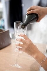 Poring champagne in glass