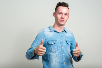 Fototapeta premium Portrait of young man against white background