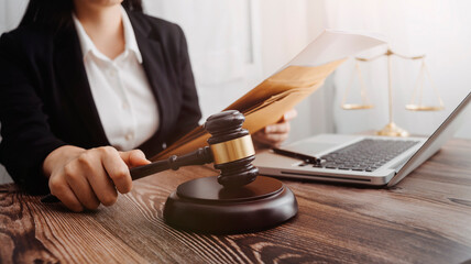 Justice and law concept.Male judge in a courtroom with the gavel, working with, computer and...