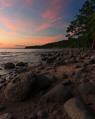 pink clouds by a rocky sea coast