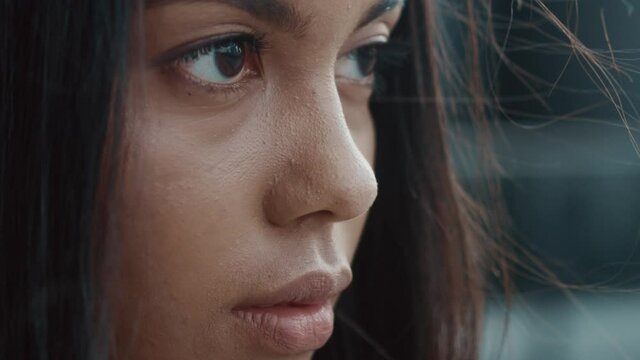 Close-up beautiful african american woman looking stright outdoors. Gorgeous face of young latin mixed-race elegant girl with brown eyes. Female portraits.