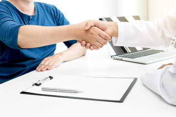 Doctors and patients shake hands after the patient has finished treatment. Medical concepts and...
