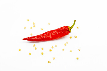 red chili pepper on a white background with seeds.