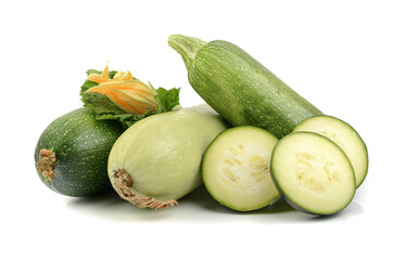 harvest of fresh courgettes with green leaves and flower, isolated on a white background