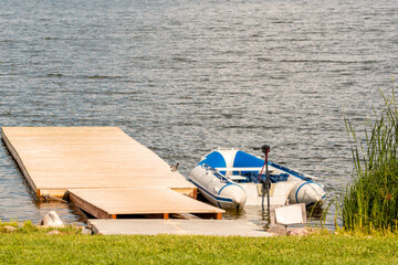 Motor boat moored to a wooden bridge