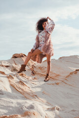  A beautiful fashionable young afro American woman posing outdoors in the shoreline