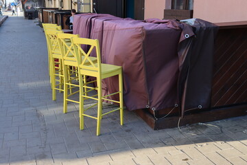 yellow chairs at pubs street in the morning