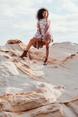 A beautiful fashionable young afro American woman posing outdoors in the shoreline