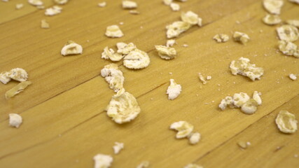 Hercules flakes on a wooden surface. Oatmeal macro shot.