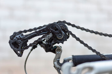the rear derailleur of the bike is broken, no wheel. close-up, on a white background © Алексей Доненко