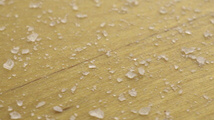 Salt on a wooden surface. Macro shot of salt crystals.