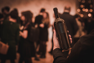 A man with a glass of red wine