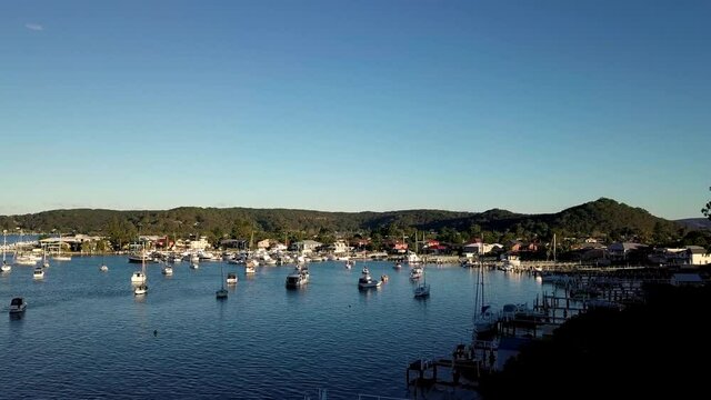 Aerial Shot Over Moored Boats Revealing Regional Town And Bush Australia