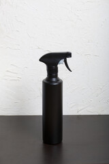 Spray bottle with antiseptic, black. For surface treatment against viruses. On a white background.