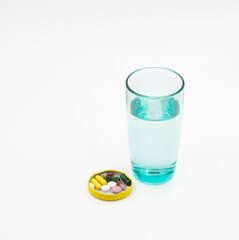 Glass of water and medicine