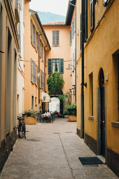 Como city - old small town in Italy - empty street with street cafe