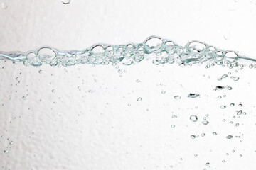 Closeup bubbles underwater on white background.
