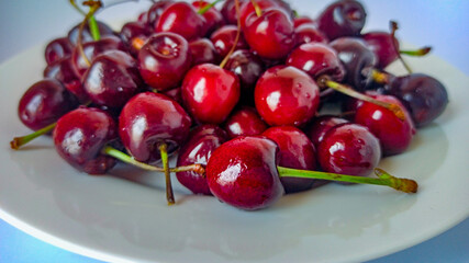  Fresh cherries on a plate background. Ripe red berries close-up. Selective focus