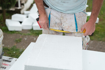 Close up of worker measuring with measure tape