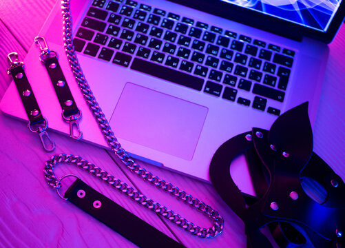 Set of erotic toys for BDSM. The game of sexual slavery with a whip, gag and leather blindfold. Intimate sex games