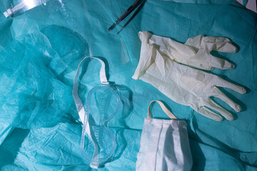 surgeon's medical accessories, glasses, gloves, mask, face shield.