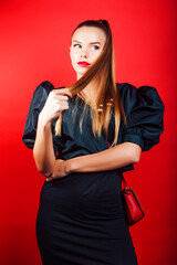 young pretty woman young lady posing on red background wearing gold jewelry, lifestyle people concept