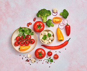 Tomato, spices, bell chili pepper, onion. Vegan diet food, creative composition on marble. Cherry tomatoes, bell pepper, broccoli, champignons layout, cooking colorful concept, top view.