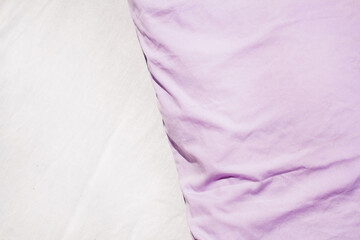 White linens and lavender pillows. Natural textiles