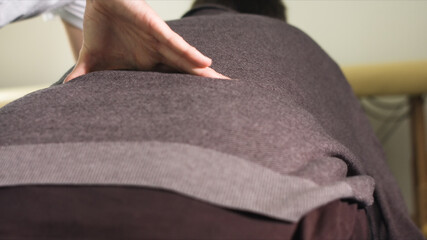 Physiotherapist exercising with disabled person on a therapy table.