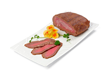 Thin pieces of sliced sausage on white plate isolated on white