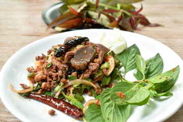 Thai spicy chop duck meat salad eat couple  fresh cabbage and Vietnamese coriander on plate