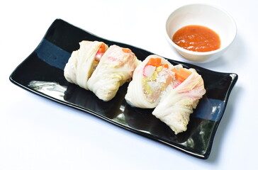 steamed Chinese cabbage stiffed glass noodles and carrot with crab stick on plate dipping sukiyaki sauce in cup